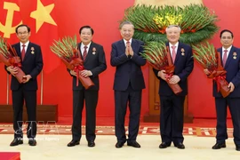 Party General Secretary To Lam presents the Military Exploit Order to the high-ranking officials on March 30. (Photo: VNA)