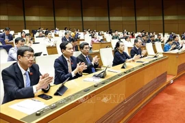 The National Assembly adopts the resolution on the International Financial Centre (IFC) in Vietnam, with 438 out of 447 legislators voting in favour, (Photo: VNA)