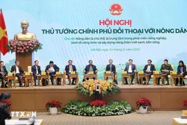 Prime Minister Pham Minh Chinh (C) chairs dialogue with farmers in 2023 (Photo: VNA)