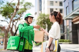 GrabMart, Grab's online grocery platform, positions itself as an express shopping assistant. (Photo: VNA) 