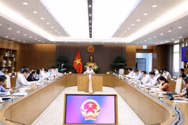 Deputy Prime Minister Nguyen Van Thang (centre) chairs a meeting on April 24 to discuss the launch of operations of the International Finance Centre. (Photo: baochinhphu.vn)