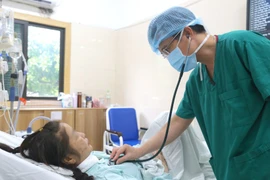 Doctor checks the patient’s health after the transplant (Photo: VietnamPlus)