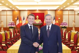 Party General Secretary To Lam (R) receives French President Emmanuel Macron in Hanoi on May 26. (Photo: VNA)