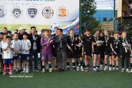 Players participate in the friendly football tournament. (Photo: VNA)