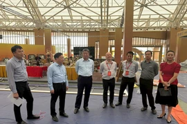Vice Chairman of the Hanoi People's Committee Nguyen Manh Quyen inspects the preparations of the space for promoting and showcasing Hanoi’s outstanding industrial and commercial products at the Autumn Fair 2025 on October 23. (Photo: VNA)
