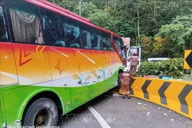 The bus is believed to have lost control and collided with two other cars, causing all three vehicles to veer out of their lane. (Photo published by VNA)