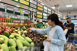 A consumer buys fruits at a supermarket in Ho Chi Minh City. (Photo: VNA)