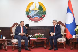 Lao Deputy Prime Minister and Minister of Foreign Affairs Thongsavan Phomvihane (right) and Vietnamese Ambassador to Laos Nguyen Minh Tam at their meeting on March 23 (Photo: VNA)