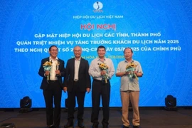 VITA Chairman Vu The Binh presents certificates of merit and insignias to units and individuals for contributions to tourism industry (Photo: VNA)