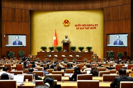 Chief Justice of the Supreme People’s Court Nguyen Van Quang presents the draft law. (Photo: VNA)
