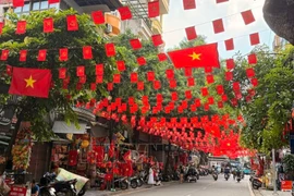 A street in Hanoi is brightly decorated with flags, flowers, banners and posters to celebrate the 80th National Day (September 2). (Photo: VNA)