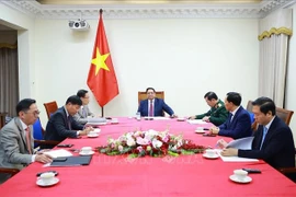 Prime Minister Pham Minh Chinh (C) holds phone talks with his Malaysian counterpart Anwar Ibrahim on December 12, 2025. (Photo: VNA)