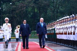 Prime Minister Pham Minh Chinh (L) and his New Zealand counterpart Christopher Luxon inspect the guard of honour. (Photo: VNA)