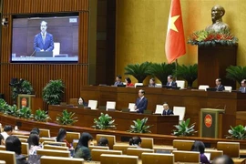 Minister of Education and Training Nguyen Kim Son answers questions raised by legislators. (Photo: VNA)