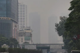 High-rise buildings on Nguyen Chi Thanh street in Hanoi are under a layer of fog (Photo: VNA)