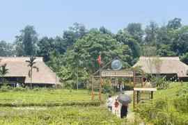 People visit the Muong village within the Vietnam National Village for Ethnic Culture and Tourism in Hanoi. (Photo: VNA)