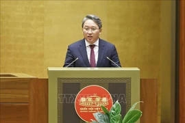 Minister of Justice Nguyen Hai Ninh presents a report on revisions to the draft resolution. (Photo: VNA)