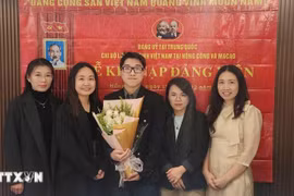 Nguyen Thi Xuan Hue (second from left), a graduate in applied English linguistics from the University of Macau (Photo: VNA)