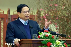 Prime Minister Pham Minh Chinh extends new year wishes to the banking sector at a meeting on February 3. (Photo: VNA)