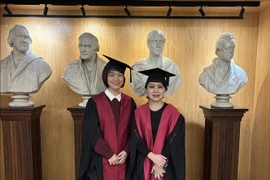 Doctors Do Thi Ngoc Linh (left) and Le Diep Linh at the RCS membership certificate award ceremony in London. (Photo: VNA)