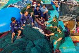 Officers and soldiers of Truong Sa border post conduct a legal education session for local fishermen. (Photo: VNA)