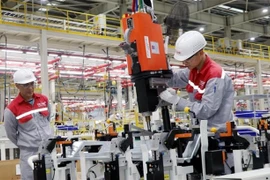 Workers assemble automotive components at Skoda's plant in Vietnam. (Photo: VNA)