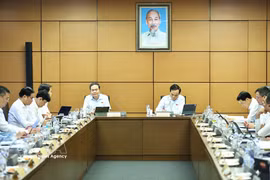 NA Chairman Tran Thanh Man (left) speaks at the group debate on August 3. (Photo: VNA)