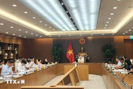 Deputy Prime Minister Nguyen Hoa Binh chairs a meeting with leaders of ministries, sectors, HCM City, and Da Nang to discuss the draft Government decree on establishing an IFC in Vietnam on October 22. (Photo: VNA)