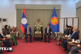 A delegation from the Vietnamese Embassy in China visits the Lao Embassy on December 1 to convey congratulations on the 50th National Day of Laos. (Photo: VNA)