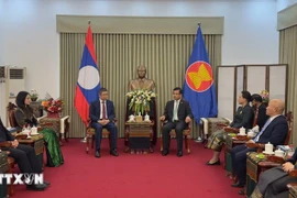 A delegation from the Vietnamese Embassy in China visits the Lao Embassy on December 1 to convey congratulations on the 50th National Day of Laos. (Photo: VNA)