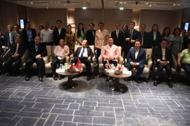 Delegates pose for a group photo at the event (Photo: VNA)