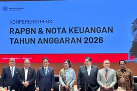 Indonesia's Minister of Finance Sri Mulyani Indrawati (centre) and other officials at the press conference (Photo: VNA)