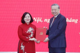 Party General Secretary To Lam (R) presents an appointment decision for the Secretary of the Party Committee of the Vietnam Fatherland Front (VFF) and Central Mass Organisations to Bui Thi Minh Hoai (Photo: VNA)