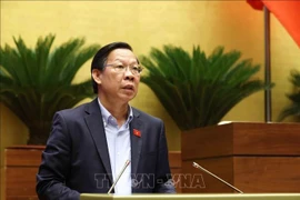 Phan Van Mai, Chairman of the National Assembly’s Committee for Economic and Financial Affairs, delivers a report presenting explanations, feedback, and revisions to the amended draft Law on Corporate Income Tax. (Photo: VNA) 