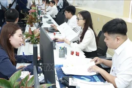 Staff members receive applications from citizens and businesses at the Ho Chi Minh City Public Administration Service Centre. (Photo: VNA)