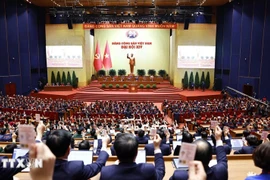 Delegates vote to adopt the resolution of the 14th National Congress of the Communist Party of Vietnam. (Photo: VNA)