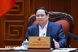 Prime Minister Pham Minh Chinh speaks at the meeting between the Government’s standing members and ministries, sectors and localities on December 16 on preparations for the ground-breaking and inauguration ceremonies for projects celebrating the 14th National Party Congress (Photo: VNA)
