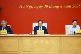Prime Minister Pham Minh Chinh (centre) chairs the meeting on August 30 to push forward the North – South high-speed railway and the Lao Cai – Hanoi – Hai Phong railway projects. (Photo: VNA)