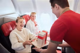 A Vietjet flight attendant offers gifts to international passengers during a flight. (Photo: courtesy of Vietjet)