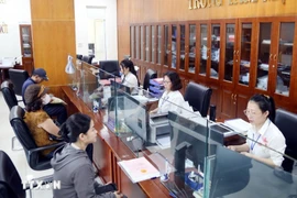 Administrative request processing at a public service centre (Photo: VNA)