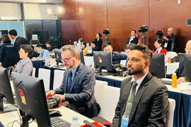International reporters cover the 14th National Party Congress at the National Convention Centre in Hanoi. (Photo: VNA)