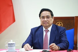 Prime Minister Pham Minh Chinh speaks at the phone talks with Angolan President Joao Manuel Goncalves Lourenco on March 16. (Photo: VNA)