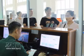 A border guard at the Tan Thanh check point, Lang Son province, enters passenger data for entry and exit. (Photo: VNA)