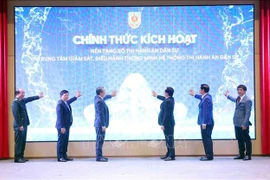 Deputy Prime Minister Ho Quoc Dung (second, left) and Minister of Justice Nguyen Hai Ninh, together with other delegates, at the launch of the national digital platform for civil judgment enforcement and the intelligent operations centre for the civil judgment enforcement system (Photo: VNA)