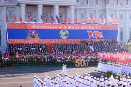 A military parade and march held to celebrate the 50th National Day of the Lao People’s Democratic Republic. (Photo: VNA)