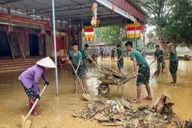 Officers and soldiers help people clean up and overcome flood consequences in Tam Giang commune of Bac Ninh province. (Photo: VNA)