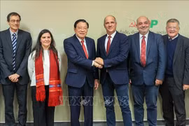 Phan Dinh Trac, Politburo member, Secretary of the Communist Party of Vietnam (CPV) Central Committee and head of its Commission for Internal Affairs, shakes hands with Paulo Raimundo, Secretary-General of the Portuguese Communist Party, during the Vietnamese Party delegation's working trip to Portugal from November 22-27. (Photo: VNA)