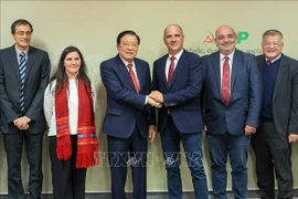 Phan Dinh Trac, Politburo member, Secretary of the Communist Party of Vietnam (CPV) Central Committee and head of its Commission for Internal Affairs, shakes hands with Paulo Raimundo, Secretary-General of the Portuguese Communist Party, during the Vietnamese Party delegation's working trip to Portugal from November 22-27. (Photo: VNA)