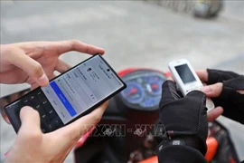 The 100 million VND monthly limit applies to money transfers and payments through a single Mobile Money account (Photo: VNA)