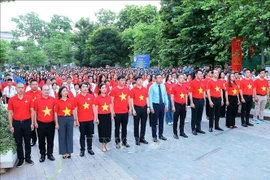 Hanoi's young people participate in a central-level flag salute ceremony at Van Xuan garden. (Photo: VNA)